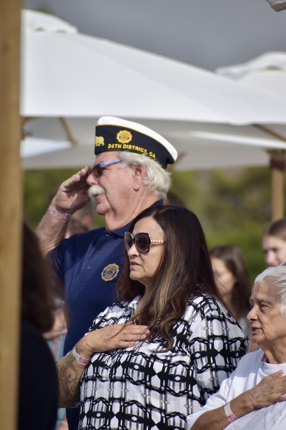 Former Army Serviceman Kevin Niles salutes during the national anthem played at the Waves of Flags on Sept. 11 at Alumni Park. Niles is member of the American Legions 24th District.