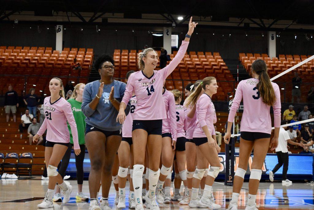 Pepperdine Indoor Women's Volleyball celebrates in a final win against UC Santa Barbara at Firestone Fieldhouse on Sept. 15. In the front of the pack, junior middle Kenadie Patterson waves to Waves fans. Photos by Mary Elisabeth