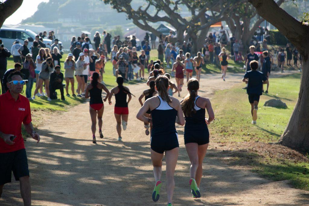 Groups of the competing Women's Cross Country teams race on Alumni Park for the Waves Invitational on Aug. 30. The women's side competed a 4K while the men's side completed a 6K.