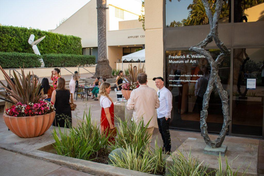 Guests enter the Frederick R. Weisman Museum of Art on Sept 7. Attendees snacked on refreshments and treats as they spoke about the art. Photo by Colton Rubsamen