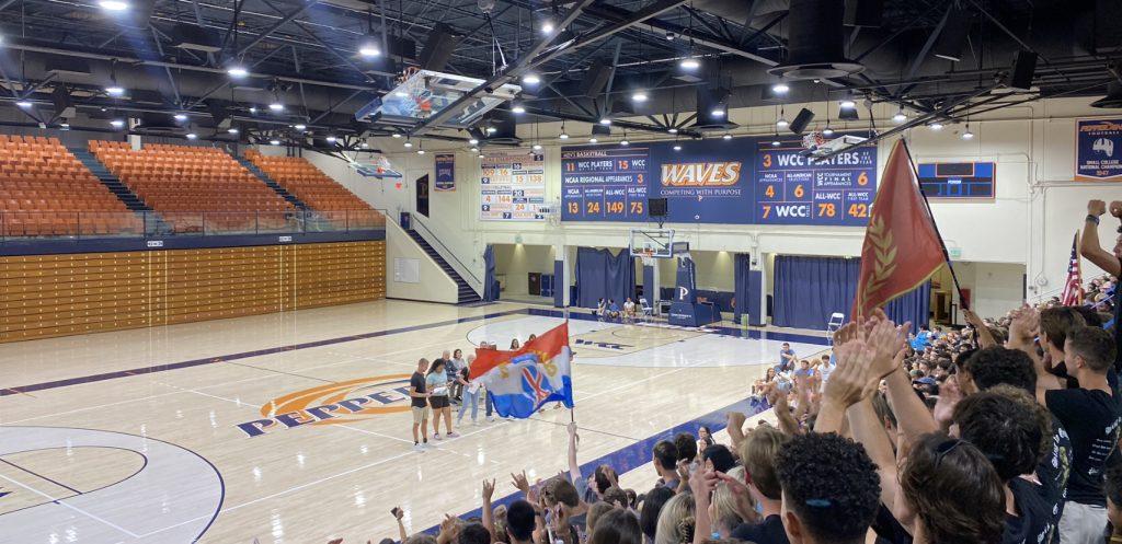 The crowd roares during Frish Follies at Firestone Fieldhouse on Aug. 17. Students cheered for first-year houses Pauley, Banowsky, White and Drescher Towers as they were welcomed to perform their chant. Photo by Karla Suzuki