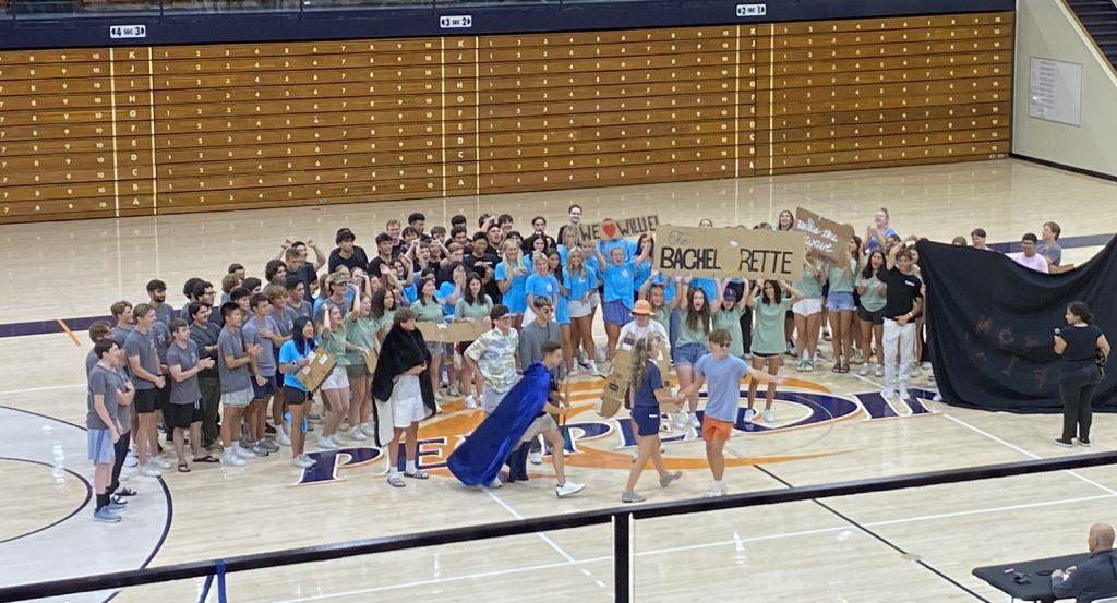 Students commit to their roles, even as they exit the floor of Firestone Field House on Aug. 17. "Georgina Pepperdine" celebrated with Willie the Wave as he was chosen to be Pepperdine&squot;s mascot in a "Bachelor" inspired skit by houses DeBell, Darnell, Eaton and Miller.