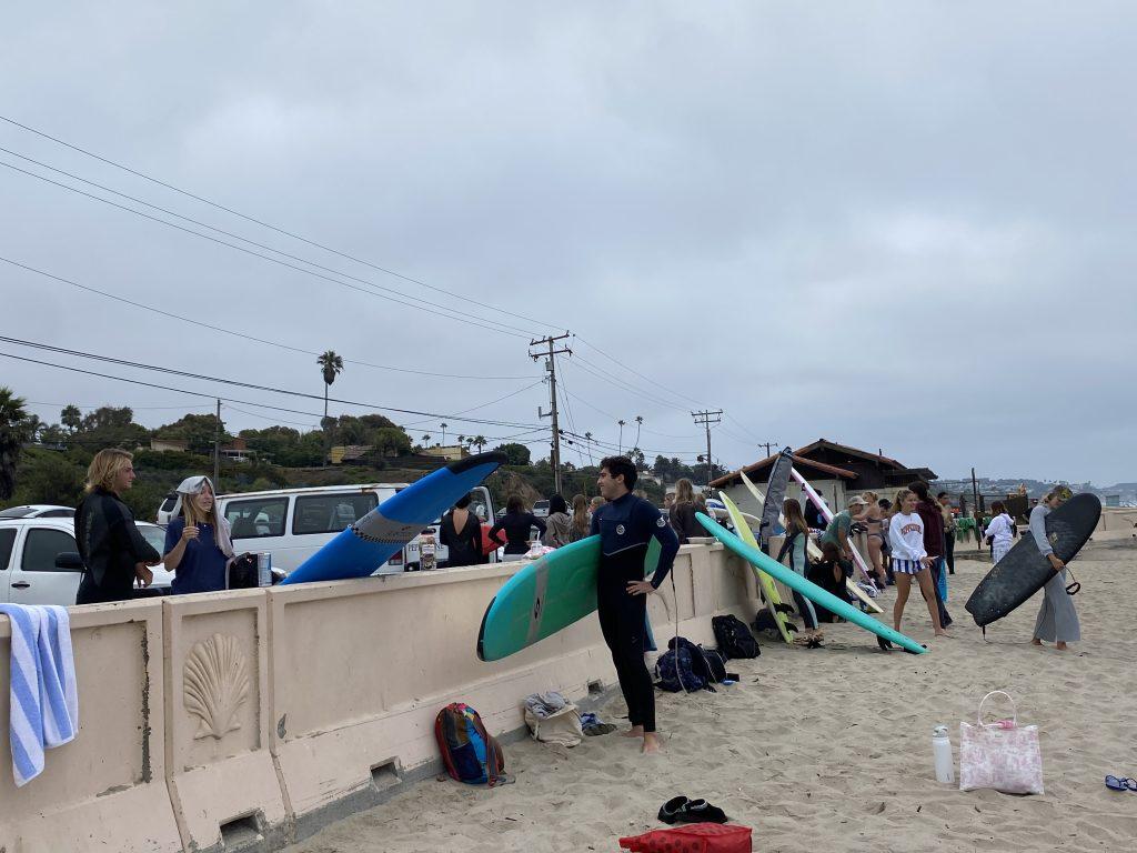 Students line up to receive a surfboard at Surf Chapel at Zuma Beach on Aug. 28. The cloudy day didn't scare off student surfers who said they looked forward to getting into the cold water. Photo by Karla Suzuki