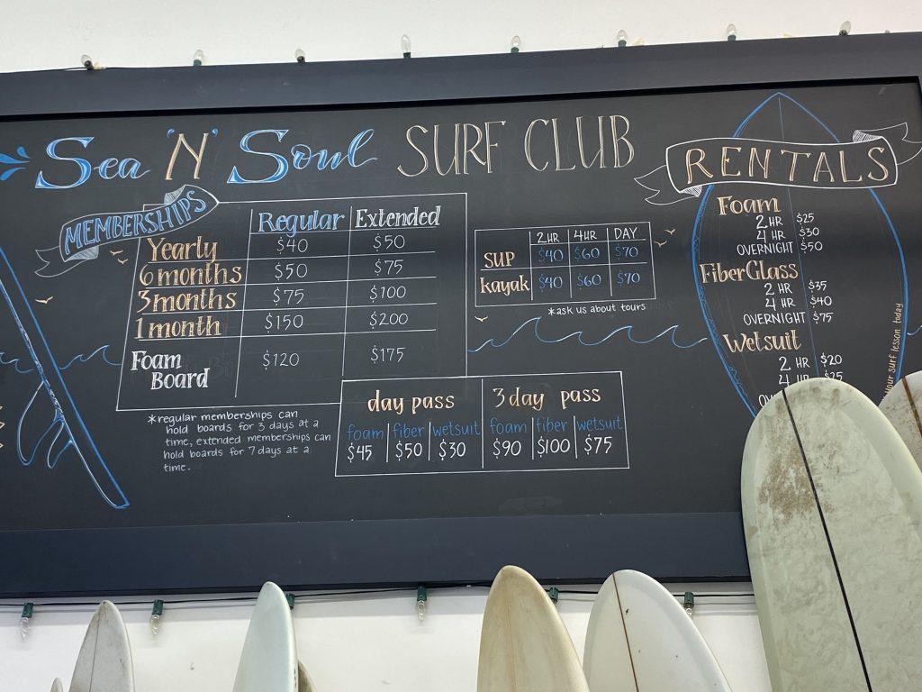 The surfing rate information chalkboard hangs from Sea N Soul's wall in Malibu on Aug. 28. Both the surfboard room and the coffee bar were filled with customers during the morning shift. Photo by Karla Suzuki