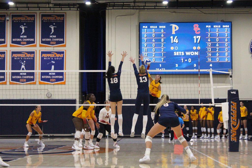 Graduate student opposite hitter Riley Simpson and freshman middle blocker Ella Piskorz jump up for the block against USC on Sept. 1, at Firestone Fieldhouse. This Waves duo was responsible for 10 blocks in this match, six for Piskorz and four for Simpson. Photos by Riley Haywood