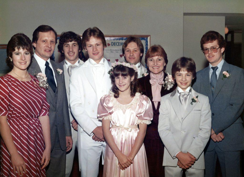 12-year-old Joline (center) stands with her family at her oldest step-brother's wedding in 1982. She was the youngest of seven growing up.