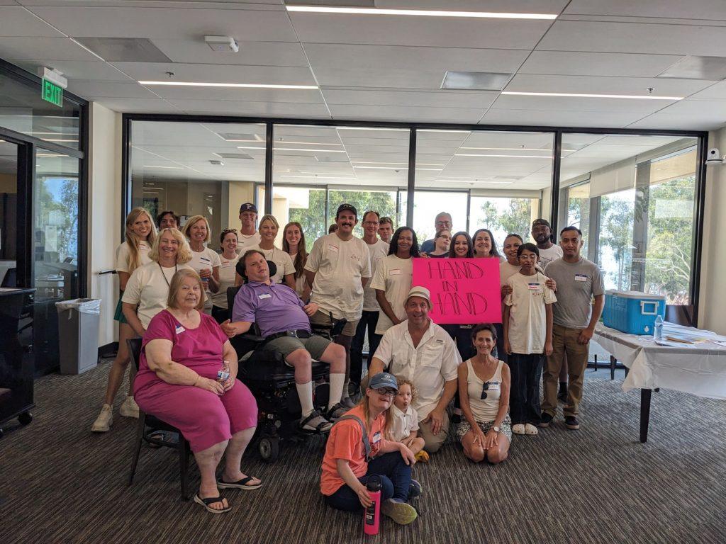 The participants of the Hand in Hand Step Forward Day project gather for a group picture. They spent time creating carnival games Sept. 7 at Pepperdine University.