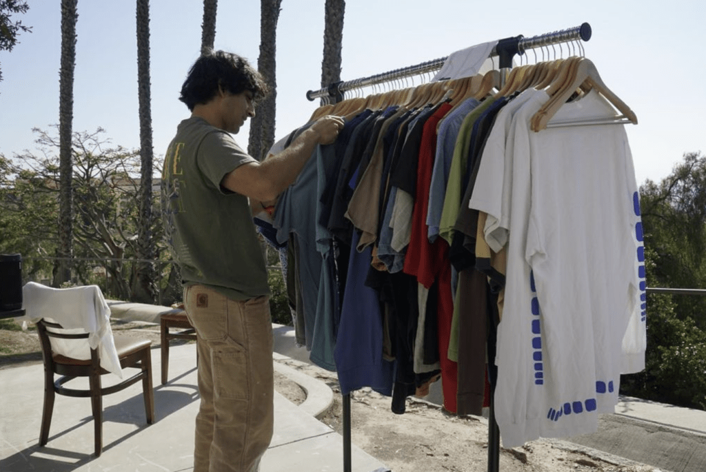 A Pepperdine student looks through a rack of curated clothing at a Thrift Malibu event March 25, 2023. Students said the events create a fun, easy atmosphere to shop sustainably and connect with others. Photos courtesy of Braeden Wooton