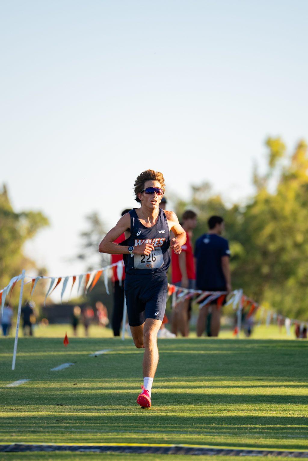 Sophomore cross country runner Gordy Nilsen runs toward the finish line Sept. 20, at the Micke Grove Golf Course. Nilsen secured the top finish for the men's team for the second straight race to open the season.