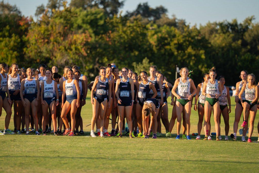 The Women's Cross Country team poses for a photo as they await their 6k race Sept. 20, at the Micke Grove Golf Course. The women's team raced against nine teams while the men's team raced seven teams.