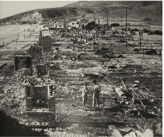 Rubble and debris cover the ground in the aftermath of the October 1929 fire. Residents were distraught but began rebuilding immediately. Photo courtesy of Ben Marcus