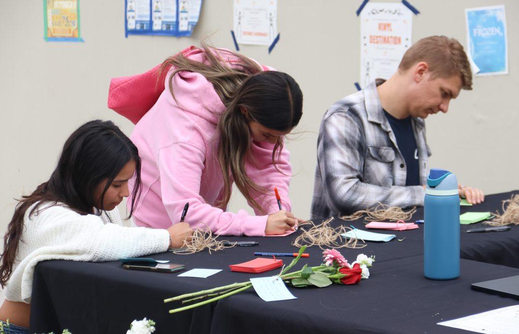 Three students write personal notes of remembrance for the four women who passed: Niamh Rolston, Peyton Stewart, Asha Weir and Deslyn Williams on Oct. 17. This marked the one-year anniversary of the PCH crash.