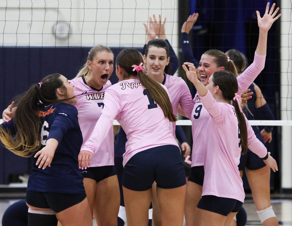 The Waves huddle together after scoring a point over the Gaels on Oct. 17, at Firestone Fieldhouse. As a team, Pepperdine was successful the entire night, topping the leaderboard in all categories except aces.