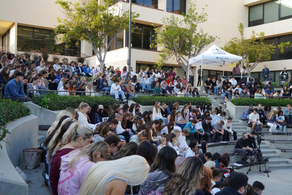 Students bow their heads in prayer during the Four Lights Remembrance Ceremony in the Amphitheatre on Oct. 17. Myers Mentzer, the Student Government Association president, led the community in the prayer.