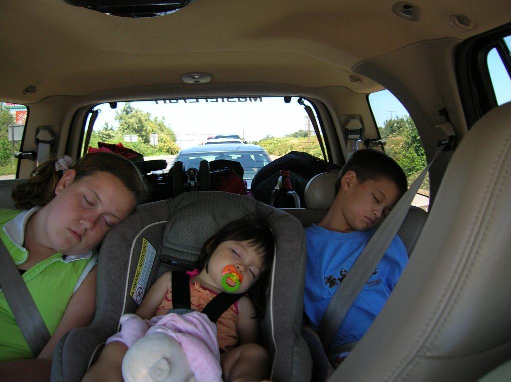 Monahan (middle) sleeps in the car alongside her cousin (left) and brother (right) in July 2006. This was one of the few times she saw her cousins before she lived closer to them.