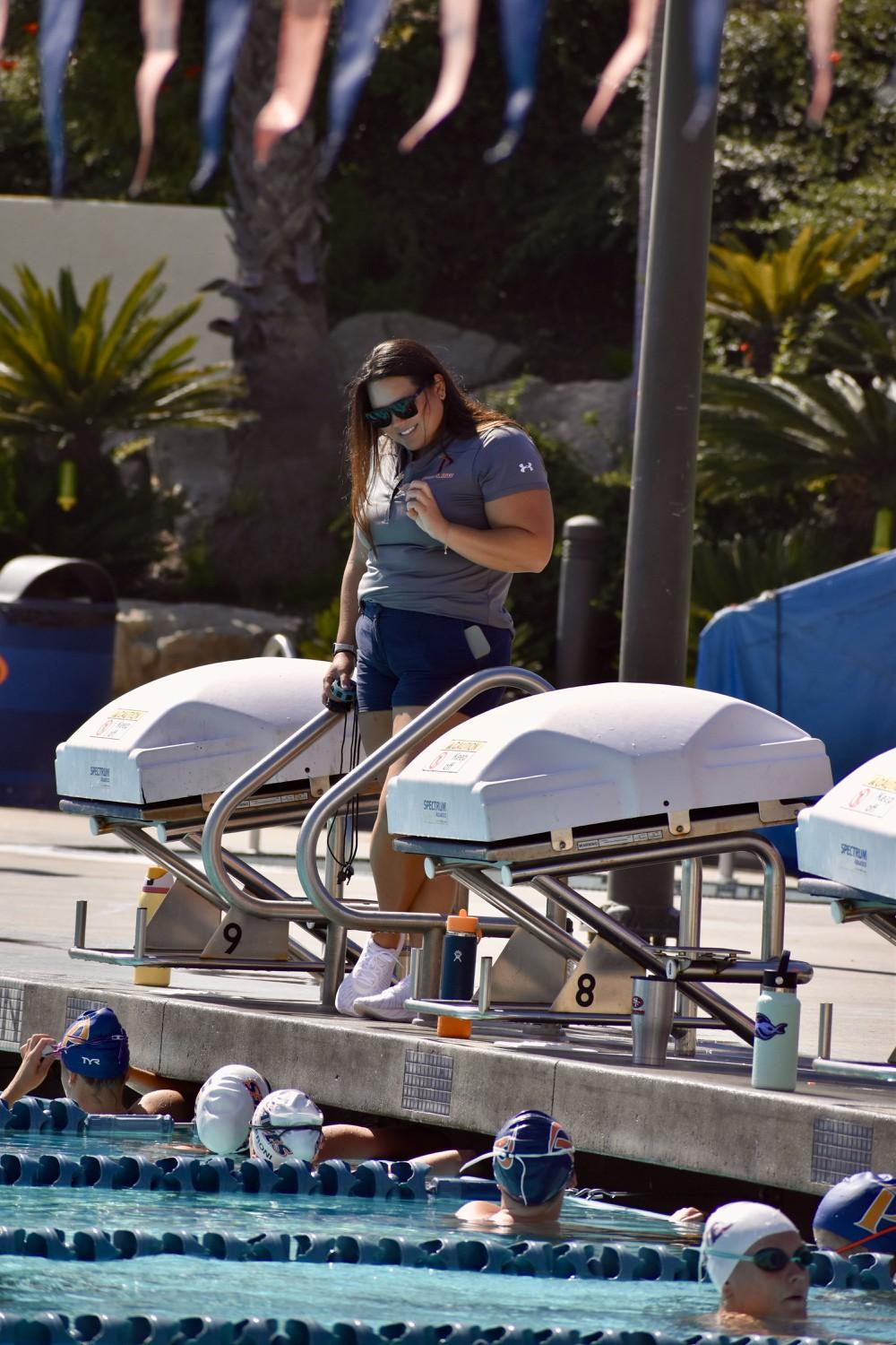 Head Coach Ellie Monobe talks to her team Oct. 2 at the Raleigh Runnels Memorial Pool during a team practice. Monobe joined the team during the 2020-21 season.