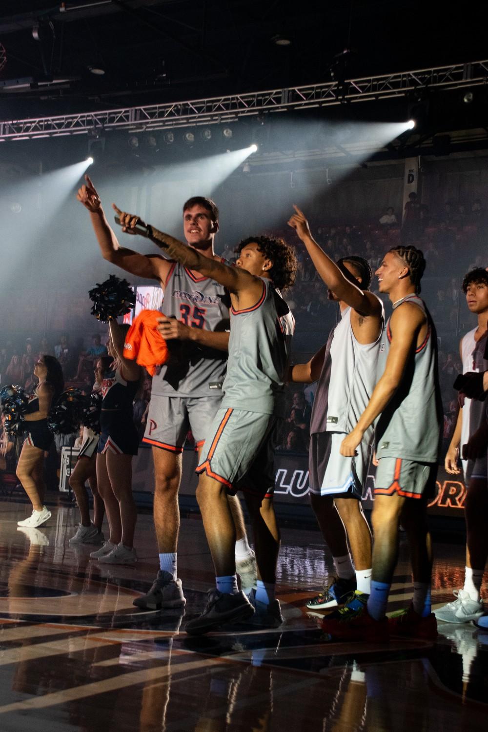 The Men's Basketball team cheers on their teammates in the dunk contest during Blue and Orange Madness on Oct. 4, at Firestone Fieldhouse. Men's Basketball season opener is a home match against Lincoln University on Nov. 2.