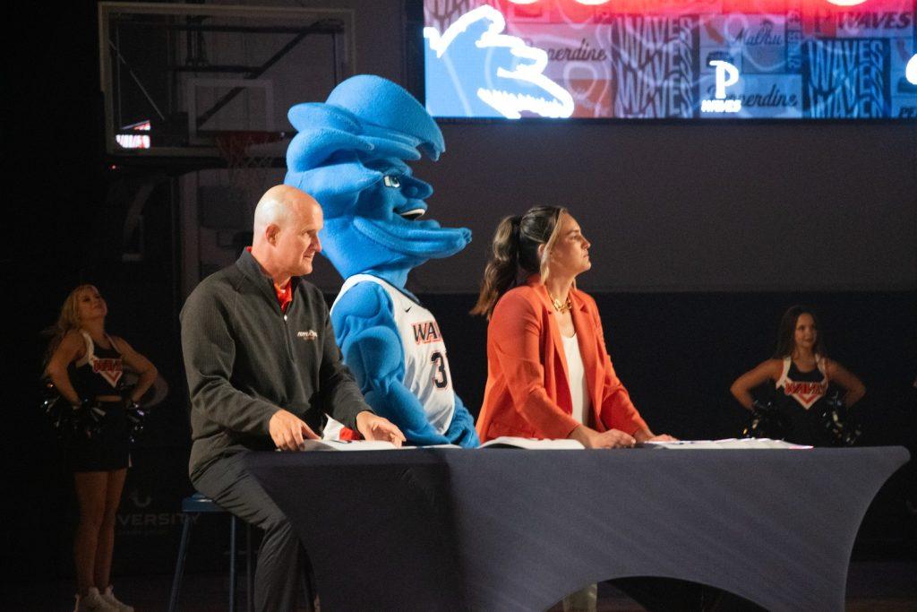 Dunk contest judges, President Jim Gash, Women's Basketball Head Coach Katie Faulkner and Willie T. Wave, await a dunk from a dunk contest contestant during Blue and Orange Madness on Oct. 4, at Firestone Fieldhouse. Returner Mager took the dub.