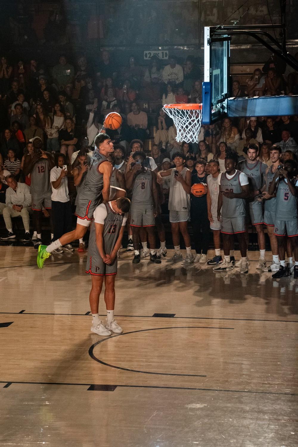 Redshirt sophomore David Mager hurdles his teammate, sophomore guard Dovydas Butka, during one of his dunk contest attempts. Mager was the only returner to this year's contest, picking up the win over freshman guards Jaxon Olvera and Taj Au-Duke