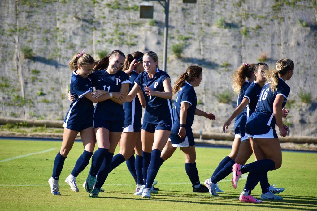 The Waves celebrate a goal Oct. 2 at Tari Frahm Rokus Field. The Waves scored two goals in the second half to come back from a 1-2 deficit.