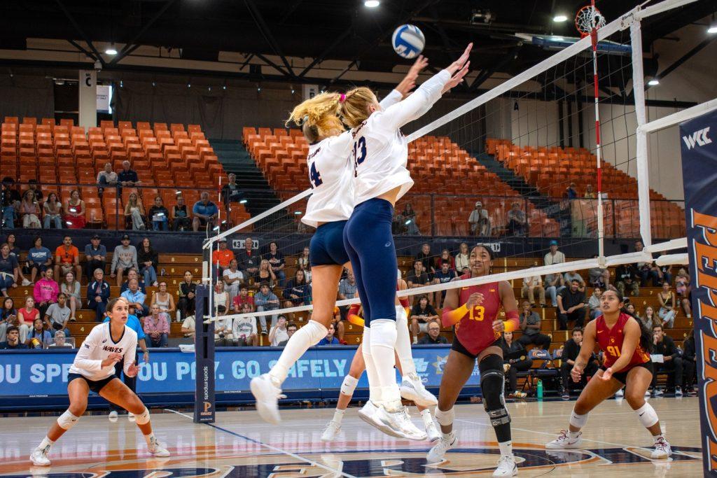 Graduate opposite hitter Riley Simpson and junior middle blocker Kenadie Patterson go up for a block against USC on Aug. 31, in Firestone Fieldhouse. The Waves are 10-8 on the year.