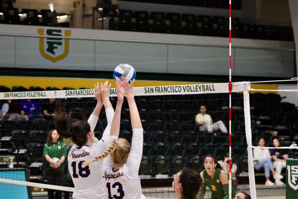 Freshman middle blocker Ella Piskorz and graduate opposite hitter Riley Simpson attempt a block on San Francisco's kill attempt Oct. 24 at the War Memorial at the Sobrato Center. Simpson and Piskorz combined for 15 kills this match.