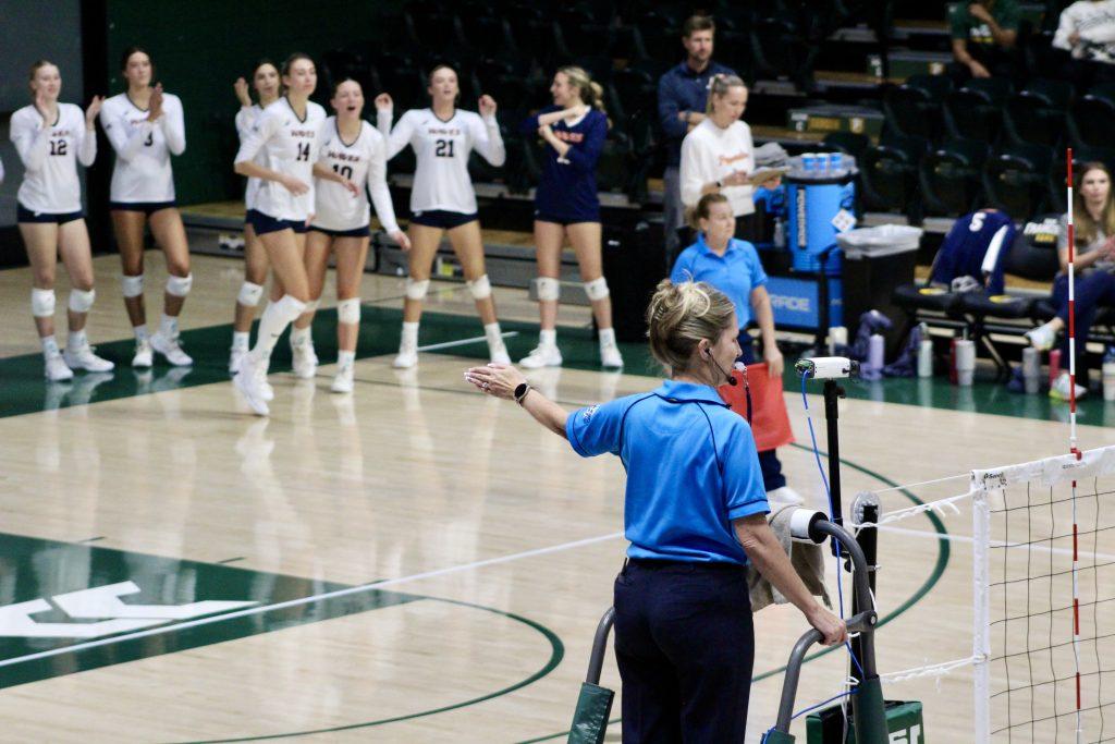 The Pepperdine Waves volleyball team rejoices as they get the point