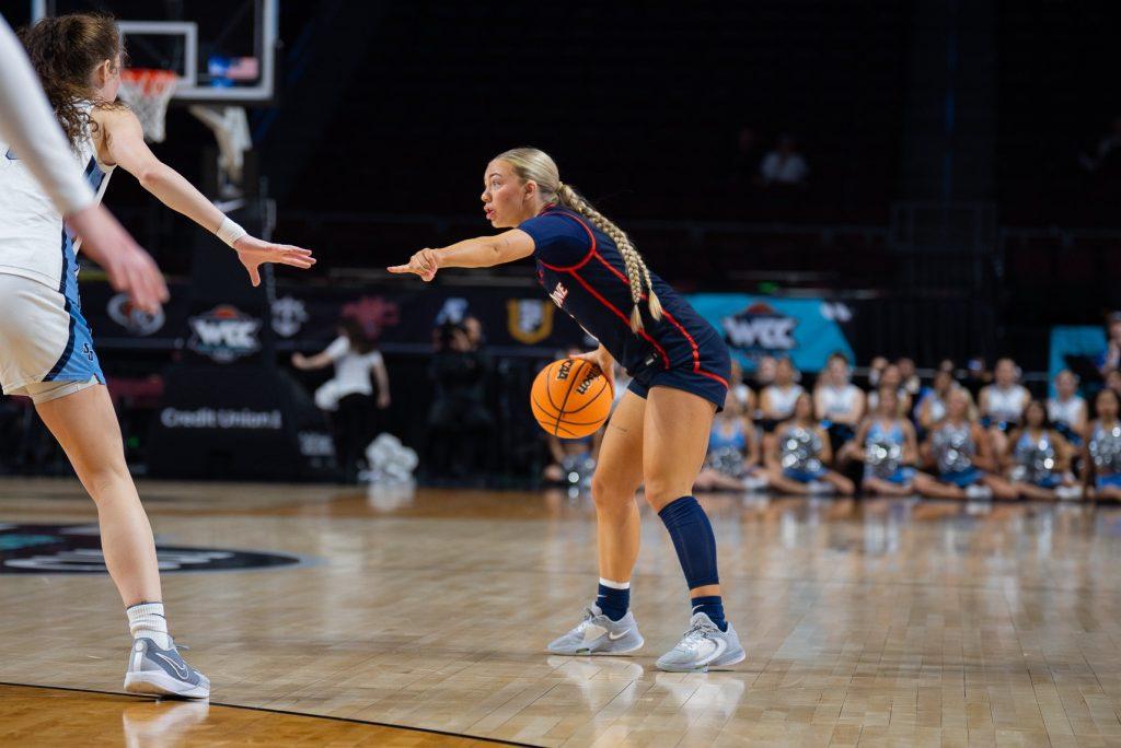 Senior guard Addi Melone handles the ball against an opponent at the WCC Vegas tournament March 2024. Melone has nearly 20k followers on Instagram and has garnered over $5000 in NIL deals. Photo courtesy of Addi Melone