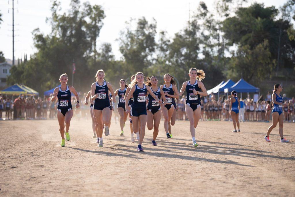 Sophomore runner Lizzy Crawford leading the Waves in a warm-up prior to the women's 6k race Oct. 19, at UC Riverside's Ag Ops Course. Crawford is climbing the charts in Pepperdine history, with her ninth consecutive race leading the team being the third-longest streak in school history.