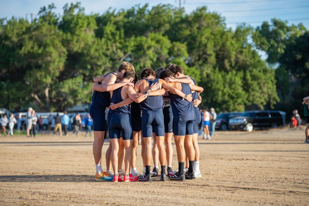 Pepperdine Men's Cross Country huddle together to prepare for their 8k race at the Highlander Invitational on Oct. 19, held at University of California, Riverside's Ag Ops Course. Photos courtesy of Kyle Cajero