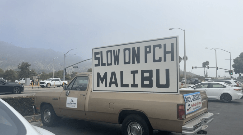 Malibu City Council Member Paul Grisanti displays his truck in the parking lot on PCH and Webb Way. Signs such as these are seen up and down the highway encouraging drivers to slow down. Photo by Jenna Parsio