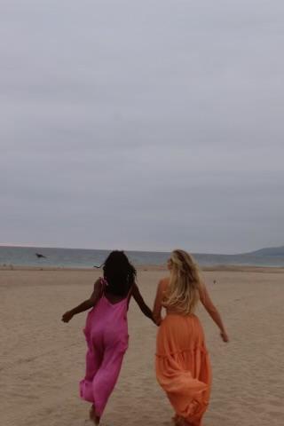 Senior Alpha Phi member Georgia Puckett runs hand-in-hand with Deslyn Williams on the beach. Puckett said she wears one of Deslyn's necklaces daily. Photo courtesy of Georgia Puckett