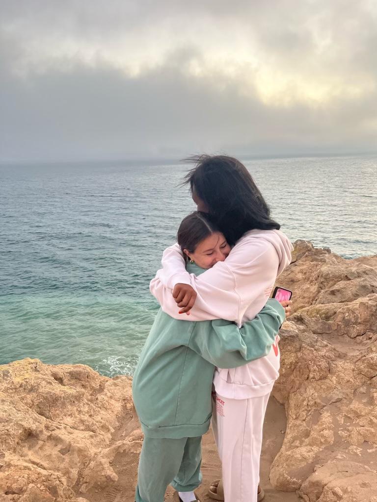 Senior Alpha Phi member Hannah Allen hugs Deslyn Williams overlooking the ocean. Allen said Deslyn was her best friend. Photo courtesy of Hannah Allen