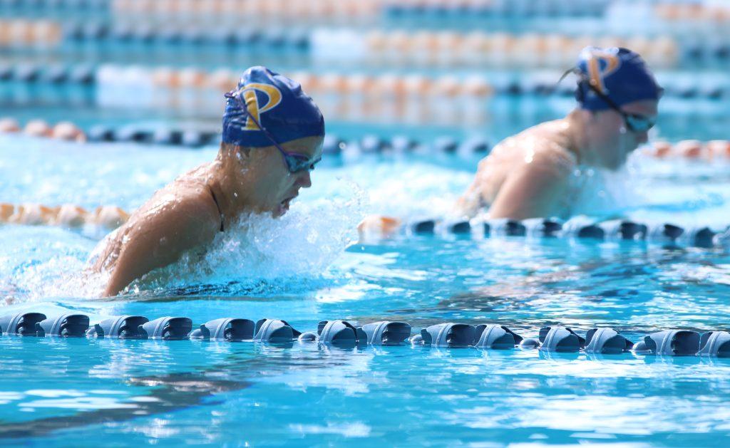 Sophomore breaststroker/IM swimmer Nora Rabe (front) and sophomore breaststroker Sydney Abild (back) races against the clock, competing in the 100-yard breaststroke event. Both athletes finished on the podium, propelling Pepperdine's winning momentum forward.