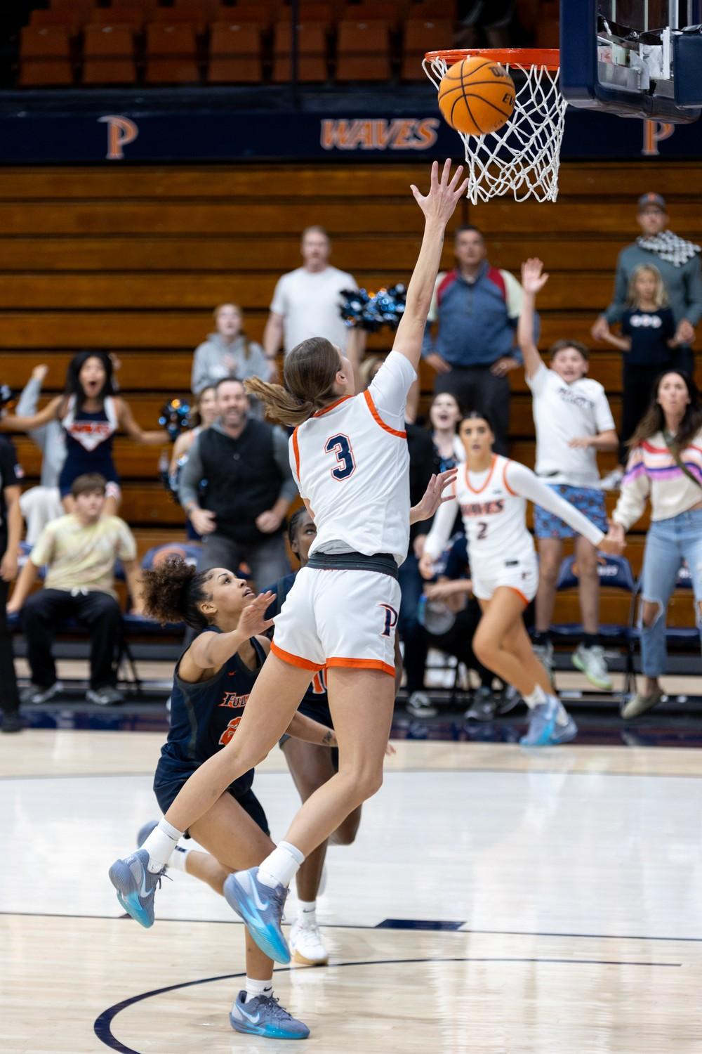 Graduate guard Ella Brubaker goes for the game winning layup late in the fourth quarter Nov. 4 at Firestone Fieldhouse. Brubaker scored 10 points in the game including six in the fourth quarter.