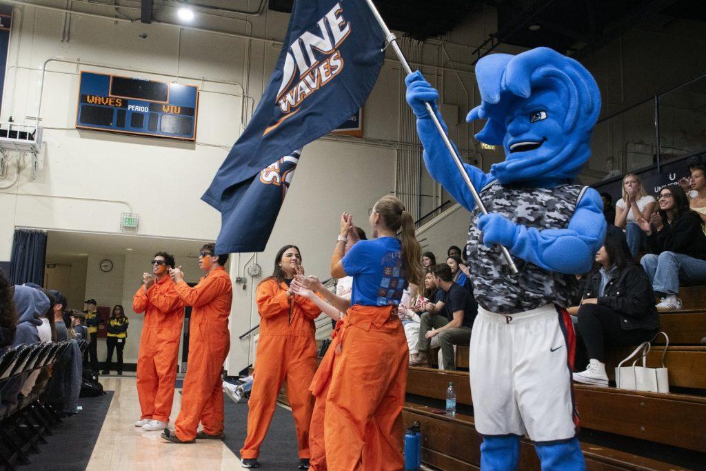 Willie T. Wave, Riptide and a group of Pepperdine students cheer on the Waves in a game against Western Illinois on Nov. 6 at Firestone Fieldhouse. Many members of the team credited the support of the home crowd for a successful home opener.