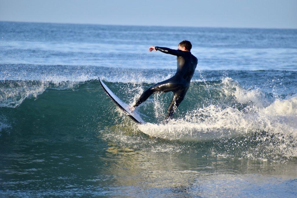 Freshman Reed Johnson surfs forehand at a Wednesday morning practice at Zuma Beach on Oct. 30. The team includes surfers of all skill ranges and across all grades.