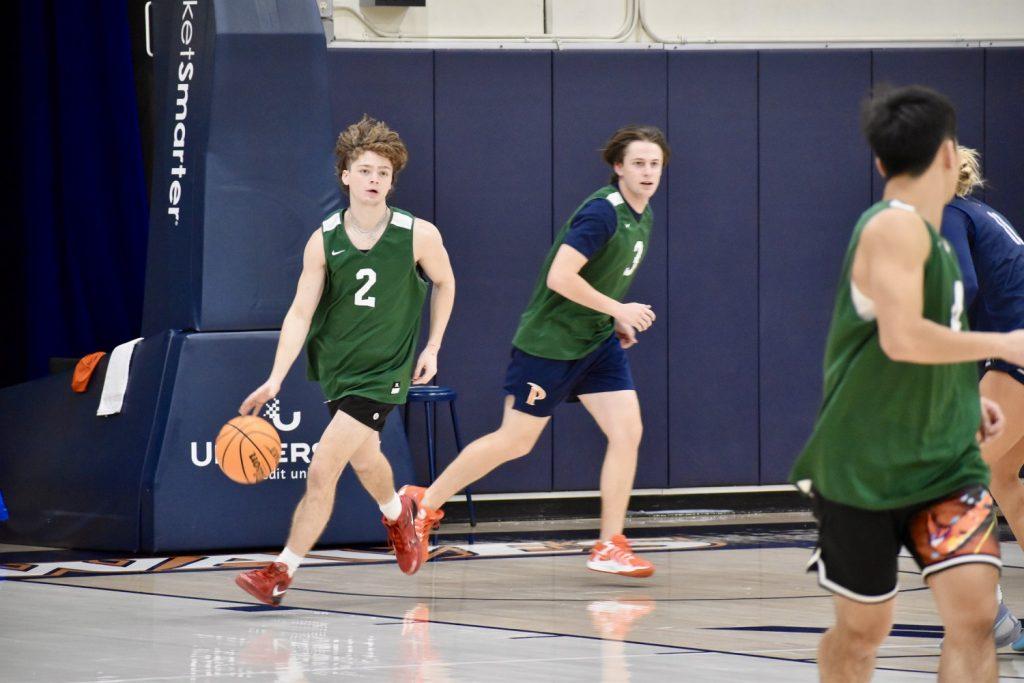 Sophomore Luke Bell dribbles a basketball up the court during a practice session Oct. 31 at Firestone Fieldhouse. Bell is in his first year as a member of the practice squad.