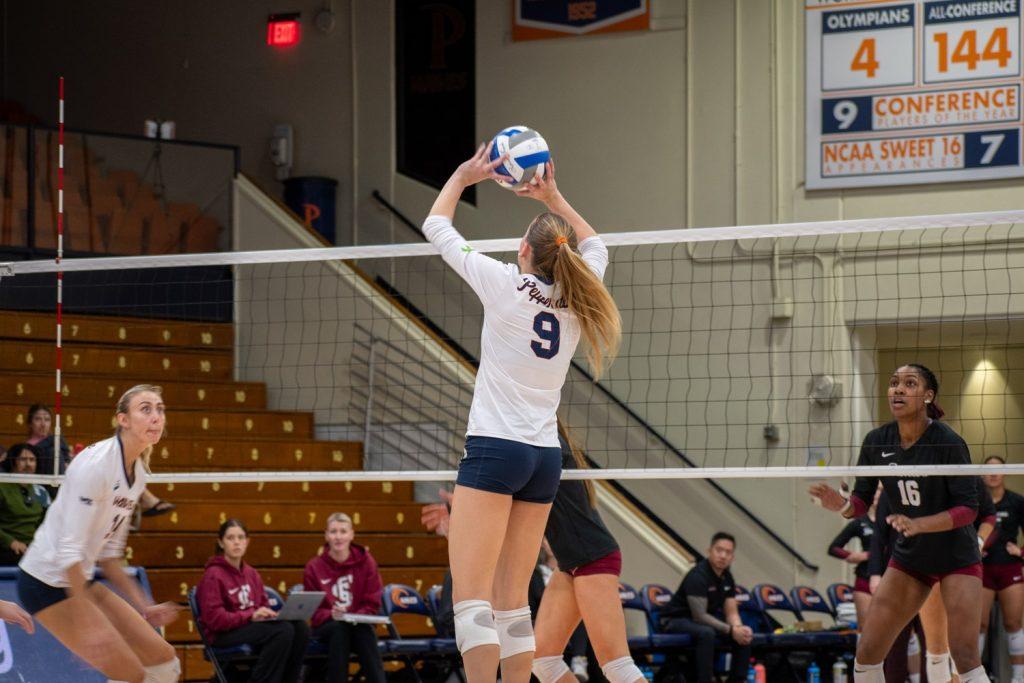 Junior setter Rosemary Archer sets the ball for junior middle blocker Kenadie Patterson on Nov. 14 at Firestone Fieldhouse. Archer ended the match with 35 assists to move to a total of 473 assists on the season.