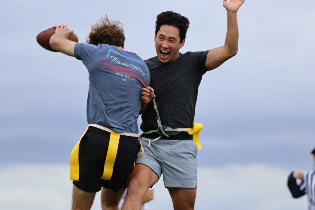 Alumni Eugene Moon ('24, right) celebrates with his teammate after scoring a touchdown during flag football intramural Sept. 30, 2023 at Alumni Park. Julian Baker, Coordinator of Recreational Sports, said he loved Campus Rec as a student at Pepperdine and hopes to spread the joy he felt. Photo courtesy of Julian Baker