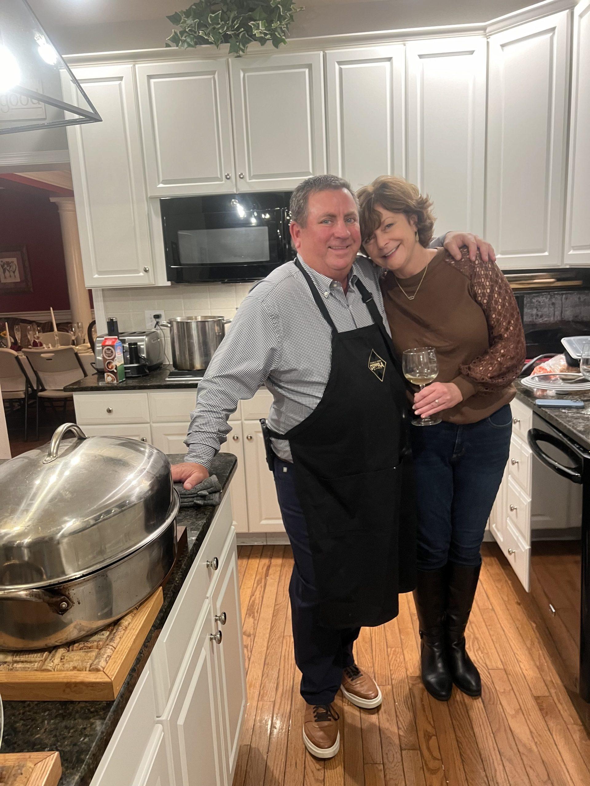 Graham's stepdad (left) and mom (right) stand in the kitchen on Thanksgiving on Nov. 23. Graham said the two use their leftovers to spread holiday cheer. Photo courtesy of Caroline Graham