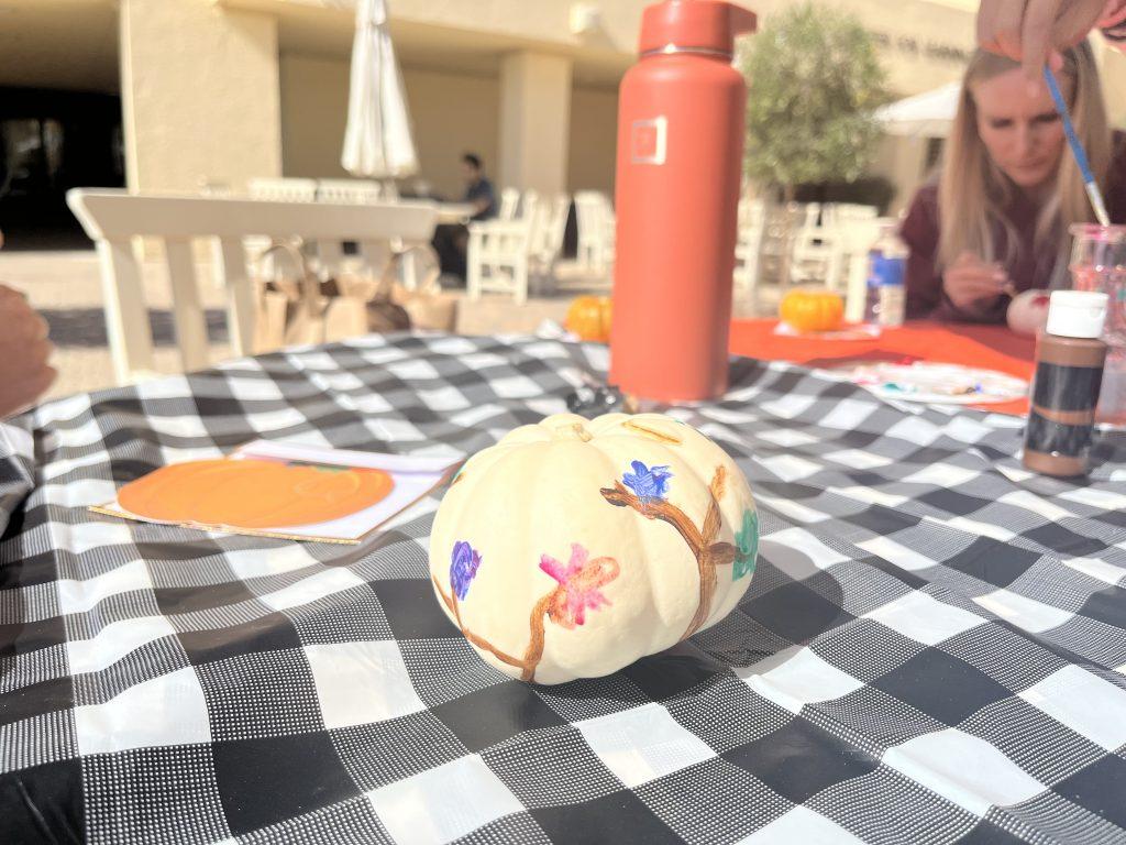 Eubank's painted pumpkin sits on one of the decorated tables at the Gulls Way Patio on Oct. 31. Eubank said she hopes to attend more RISE events like this because they seem fun and inviting.