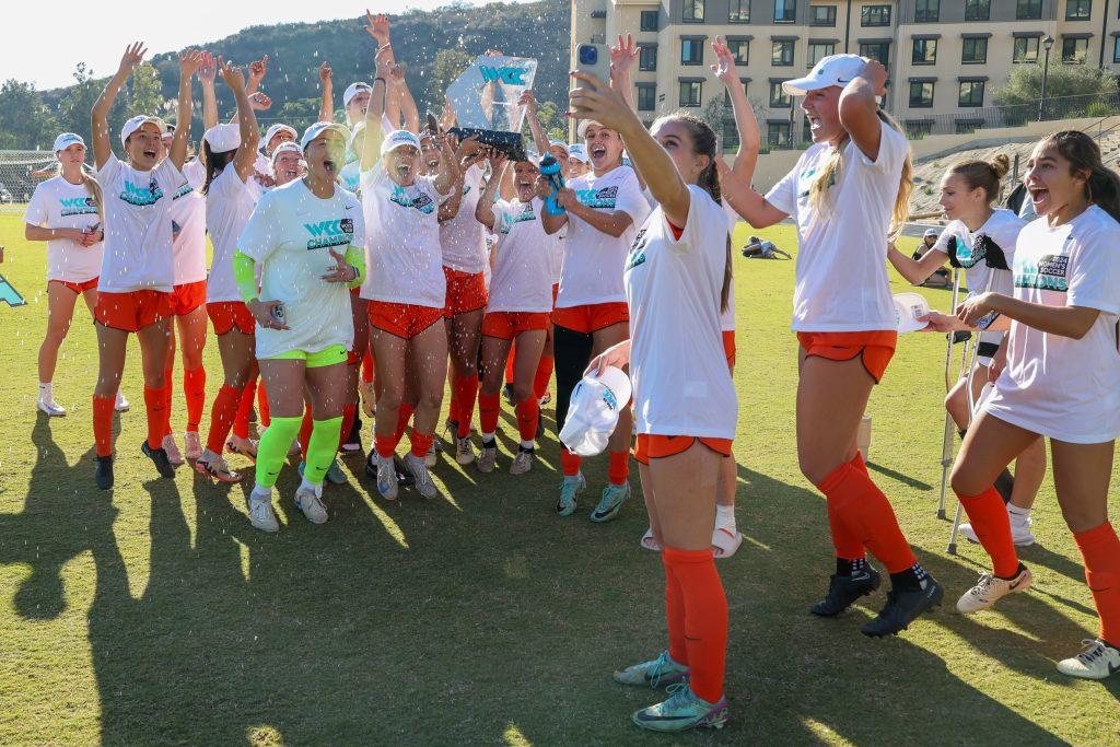 Pepperdine celebrates a title win with the WCC trophy Nov. 9 at Tari Frahm Rokus Field. The Waves fifth WCC championship is the team's first since 2017. Photo courtesy of Pepperdine Athletics