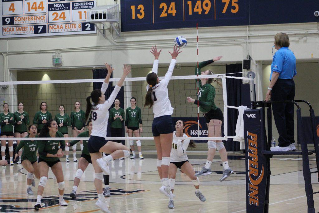 Senior outside hitter/opposite Grace Chillingworth and freshman middle blocker Ella Piskorz jump for a block against the University of San Francisco on Nov. 16 at Firestone Fieldhouse. Chillingworth and Piskorz have combined for 150 total blocks this season.