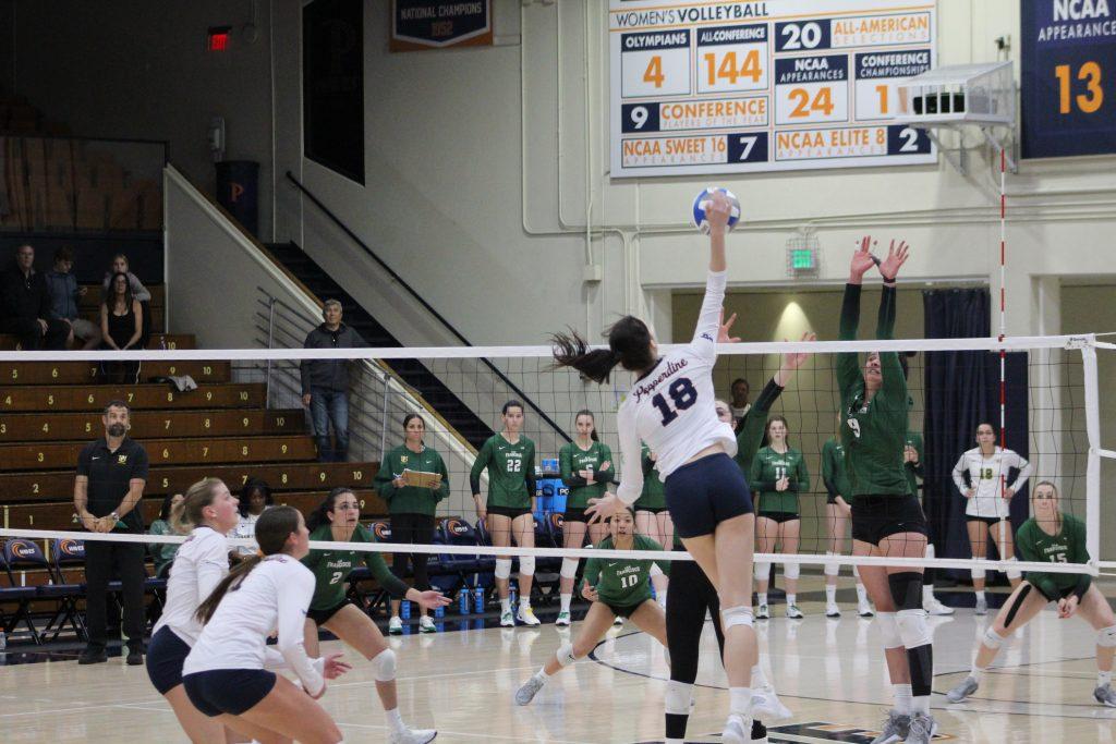 Freshman middle blocker Ella Piskorz spikes the ball against the University of San Francisco on Nov. 16 at Firestone Fieldhouse. Piskorz has collected one WCC Defensive Player of the Week and one WCC Freshman of the Week this season.