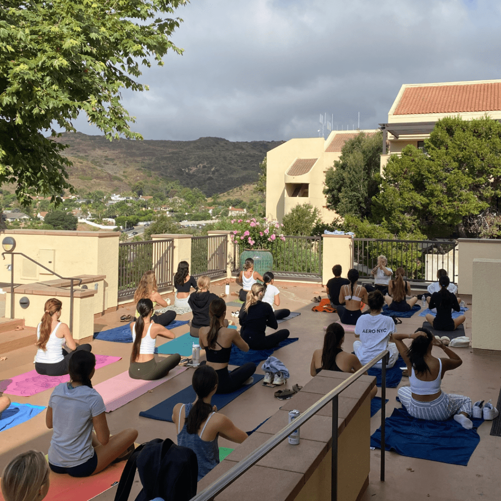 The RISE Yoga Chapel builds skills for resilience through mindfulness and movement every Wednesday at the Lighthouse patio. Yoga instructor Emmalee Strait led Yoga Chapel for all first and second year students throughout the semester. Photo courtesy of Isabella Knudson