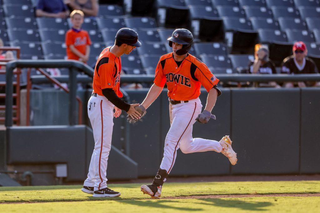 Cook high-fives the Baysox third base coach as he rounds third base following a homer in a game for the Baysox. Cook played 135 games for the Baysox from '23-'24 before getting called up to the Norfolk Tides after just 15 games in 2024. Photo courtesy of Billy Cook