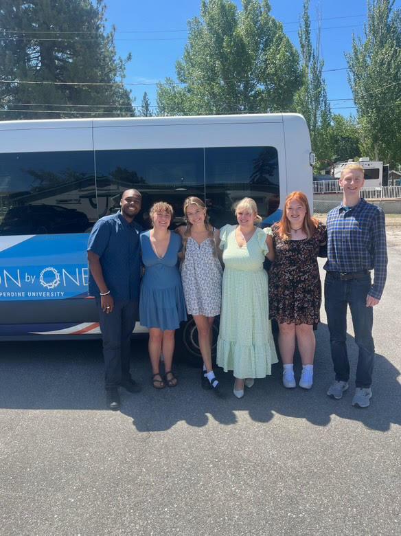 Won by One poses outside their van for a picture in the fall of 2024. They spent time together at Big Bear getting to know each other.