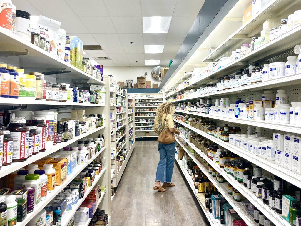 A shopper browses the array of vitamins and supplements Vitamin Barn has to offer Oct. 10. Vitamin Barn buyer and consultant Lucia Yafi said customers come when searching for a product that supports their lifestyle centered around being active and healthy. Photo by Bohuen Tong