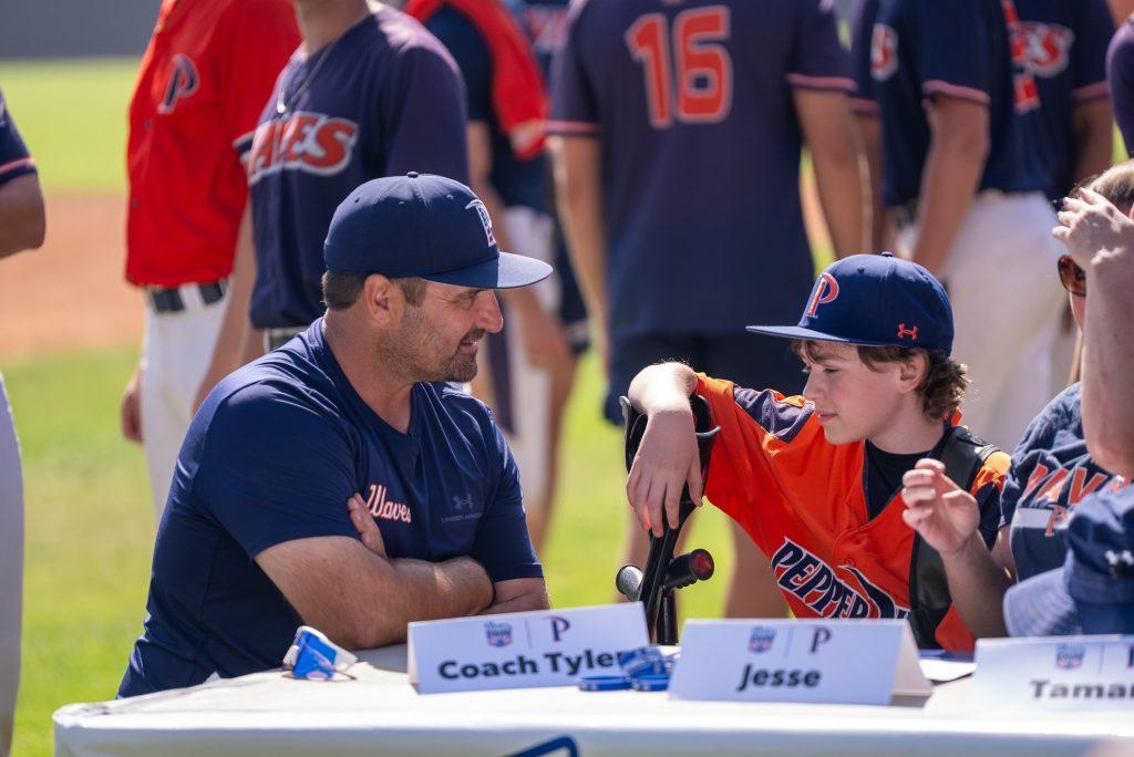 Tyler LaTorre celebrates the organization GoTeamImpact with the Men's Baseball team at Eddy D. Field Stadium on Oct. 12, welcoming Jesse as an honorary Wave. The Pepperdine Men’s Baseball team has an exciting upcoming season under his direction. Photo courtesy of Pepperdine Athletics